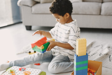 Child play with a colored constructor on floor
