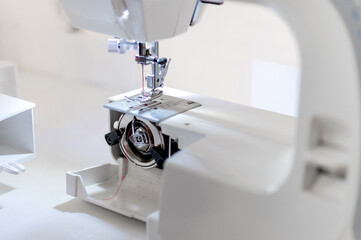 Sewing hobby background. Close up process of sewing on a sewing machine with copy space.