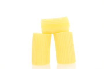 Bright yellow uncooked pasta, close-up, isolated on white.