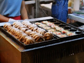 Fresh grilled squid on charcoal grill,Roast octopus on white plate.Seafood on street food,Thailand.