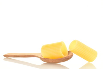 Bright yellow organic, uncooked pasta with a wooden spoon, close-up, isolated on white.