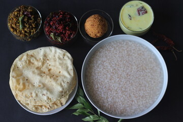 Rice porridge or Kanji along with Coconut chutney, Beetroot potato thoran, stir fried moong, Fried papad and Tempered buttermilk