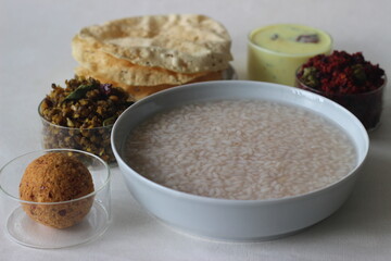 Rice porridge or Kanji along with Coconut chutney, Beetroot potato thoran, stir fried moong, Fried papad and Tempered buttermilk.