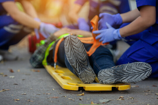 Selective Focus Shoe . Team Paramedic Firs Aid Accident On Road. Ambulance Emergency Service. First Aid Procedure.