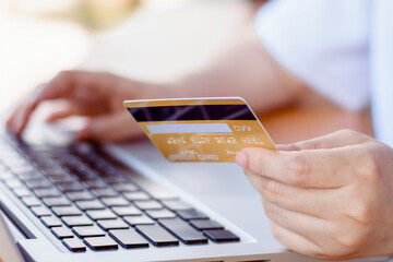 Online Payment . Woman hands holding credit card and using laptop. Online shopping