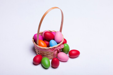 Basket with easter eggs isolated on white background