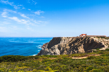 The cape Espichel with the Sanctuary of Nossa Senhora da Pedra Mua and the atlantic ocean in a summer day