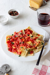 Ravioli with tomato sauce, spinach and parmesan cheese. Healthy eating. Vegetarian food. Italian cuisine.