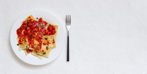Ravioli with tomato sauce, spinach and parmesan cheese. Healthy eating. Vegetarian food. Italian cuisine.