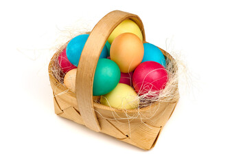 Colorful easter eggs in basket, isolated on white background