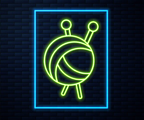 Glowing neon line Yarn ball with knitting needles icon isolated on brick wall background. Label for hand made, knitting or tailor shop. Vector