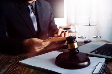 Business and lawyers discussing contract papers with brass scale on desk in office. Law, legal...