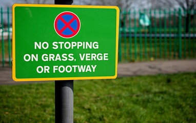 UK road sign No stopping on grass verge or footway.