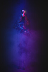 Fototapeta premium Cyberpunk girl soldier with a rifle in the neon lights concept.