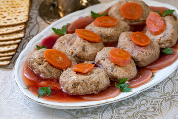 Gefilte fish. Fish cakes on a platter, decorated with beets, markers and parsley.