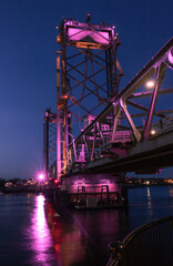 Fototapeta na wymiar Colorful bridge illuminated at sunset and blue hour