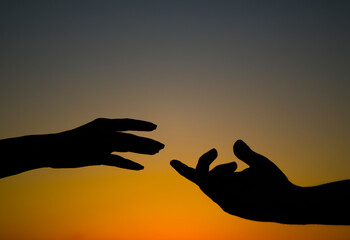 Fototapeta na wymiar silhouette of hands. Help. Hope. Light. Sunset. 
