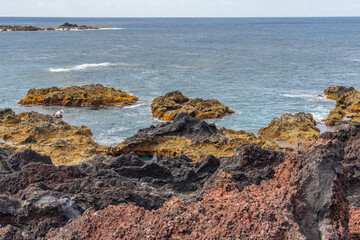 Fototapeta na wymiar Natural volcanic rocks near Ponta da Ferraria, Sao Miguel island, Azores