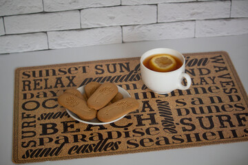 cup of tea with lemon and cookies 