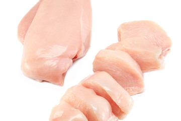 Fresh raw chicken breast fillet whole and sliced isolated closeup on white background, clipping path