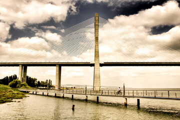 Vasco Da Gama bridge perspectives under cloudy sky in Lisbon