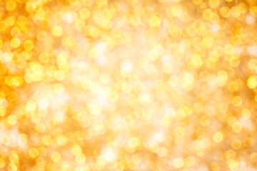 Golden bokeh pattern. Abstract background blurred beautiful shiny gold lights Christmas. Bright twinkle lights festive.