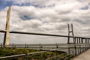 Vasco Da Gama bridge perspectives under cloudy sky in Lisbon