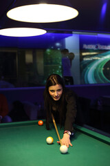 Young brunette girl playing snooker