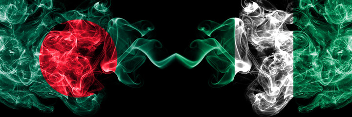 Bangladesh, Bangladeshi vs Nigeria, Nigerian smoky mystic flags placed side by side. Thick colored silky abstract smokes flags.