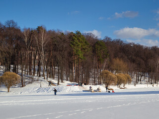 Fototapeta na wymiar Promenade at sunny day at the lake in Tsaritsyno park