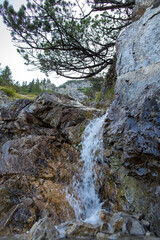 travel germany and bavaria, water flowing over a stone wall on the top of a mountain