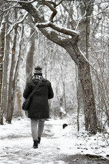Fototapeta na wymiar Woman from behind walking in forest