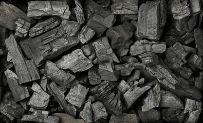 Background texture of many black charcoal pieces - obrazy, fototapety, plakaty