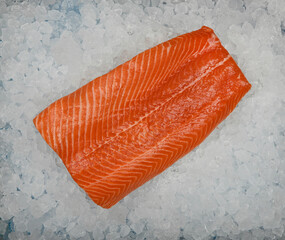 Close up raw salmon fish fillet on crushed ice