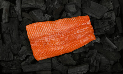 Cooking raw salmon fish fillet on charcoal