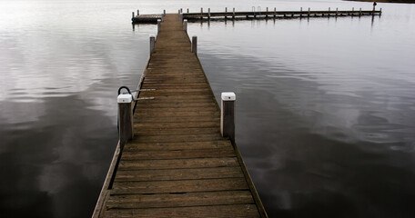Fototapeta premium Pier on the Reeuwijkse Plassen (Lake, The Netherlands), created by digging for peat, now very popular for watersports and recreation.