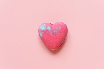 Heart shaped bath bomb on the pink background. Copy space. Heart symbol. 