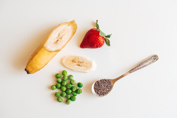 strawberry, banana, green peas on the table