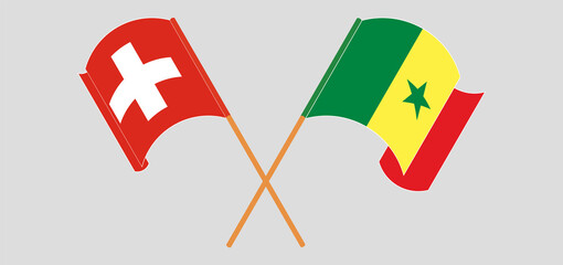 Crossed and waving flags of Switzerland and Senegal