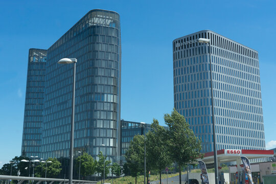Munich, Bavaria, Germany - July 05, 2020: modern business skyscrapers "Bavaria Towers" , office towers and new hotel building of the "Hyperion" with glass facade, in the fore an "Esso" filling station