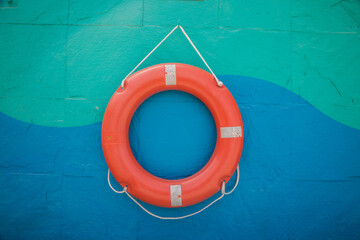 Lifebuoy hanging on a colorful wall