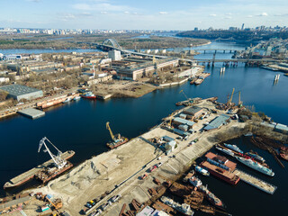 Aerial view of moored old barges and ships in river port