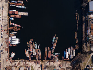 Aerial view of moored old barges and ships in river port