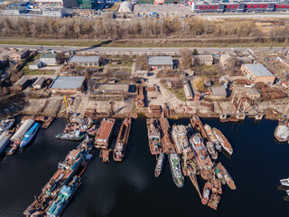 Aerial view of moored old barges and ships in river port