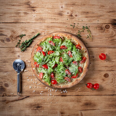 Fototapeta na wymiar Vegetarian pizza on a wooden background. Top view. Flat lay