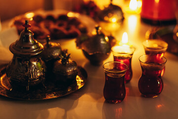 Classic Turkish tea drinking. Turkish tea in a real glass cup and copper teapot.