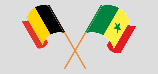 Crossed and waving flags of Belgium and Senegal