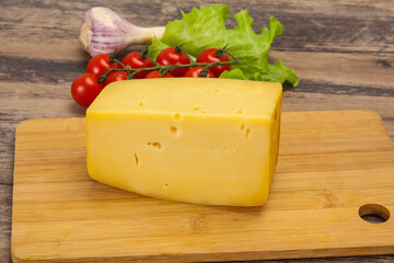 Hard yellow tasty cheese brick
