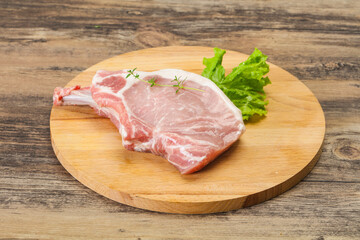 Raw pork bone steak over wooden