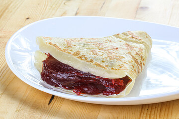 Delicous pancake with fruit jam
